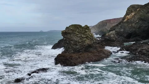 Waves at Storm in slow motion over rocks and cliffs from a drone, Cornwall Stock-Footage 280090219