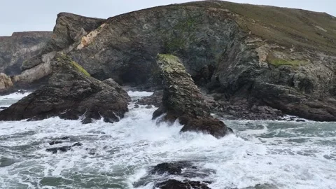 Waves at Storm in slow motion over rocks and cliffs from a drone, Cornwall Stock Footage 280090247