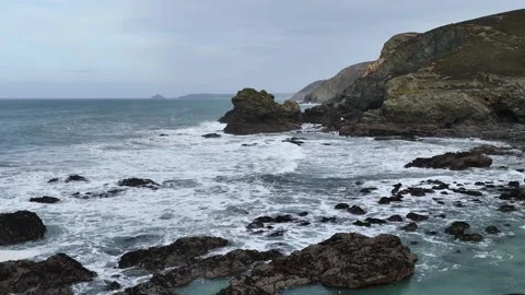 Waves at Storm in slow motion over rocks and cliffs from a drone, Cornwall Stock Footage 280090355