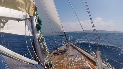 Waves strike the front of sailboat with passengers, slow motion Stock Footage 116257800