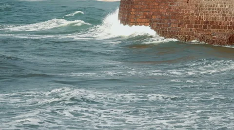 Waves strike the stone wall Stock Footage