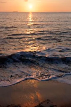 Waves at sunset Stock Photos