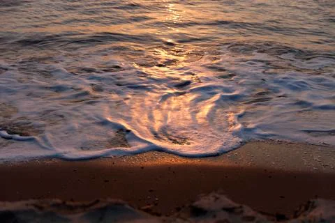 Waves at sunset Stock Photos