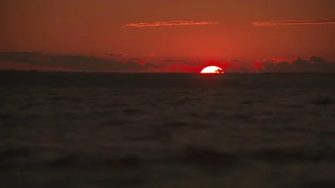 Waves at sunset in slow-motion, pan down from sky to water at 29,97 fps Stock Footage 84993712