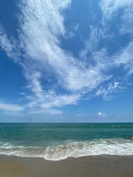 Waves, surf, ocean, clouds and sky Stock Photos