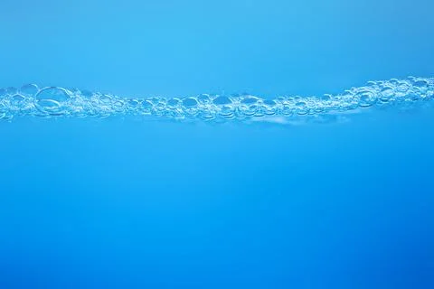 Waves on the surface of clear water such as in the sea or fish tank backgroun Stock Photos