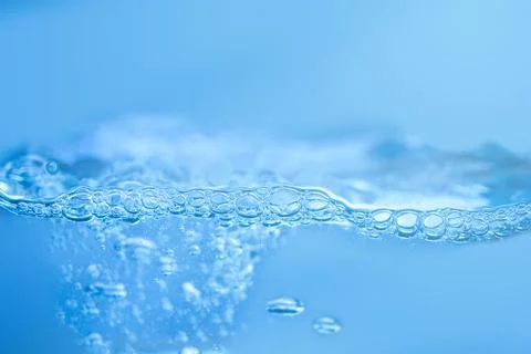 Waves on the surface of clear water such as in the sea or fish tank backgroun Stock Photos