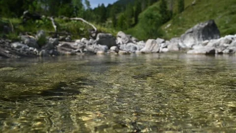 Waves on the surface of flowing water from a mountain stream (slow motion) Stock-Footage 260844880