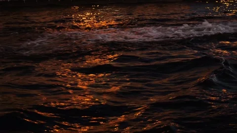 Waves on surface of river at night with reflecting city lights Stock Footage 295102958