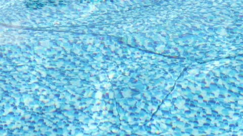 Waves on the surface of the water in the pool, blurry glare on the water Stock Footage 235169991