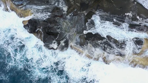 Waves surging onto rocks drone overhead static Stock-Footage 126267536