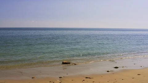 Waves throw guitar on shore or beach. Acoustic guitar floats, swims, drifts Video stock 126803196