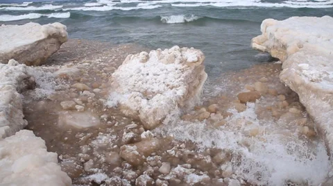 Waves tossing ice chunk around Stock Footage 35544212