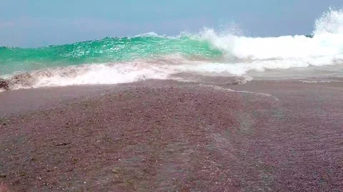 Waves touching down at feet of Hindu Relic Stock Footage 132209296