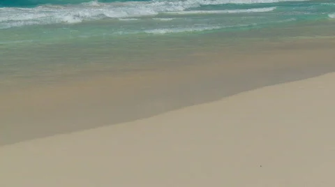 Waves touching sandy beach close Stock Footage