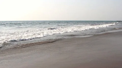 Waves touching sandy beach Stock Footage 50681711
