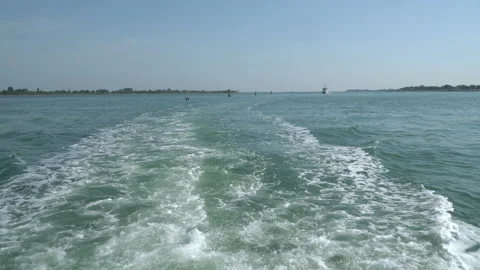 Waves trail behind a small boat moving. Stock Footage 202203656