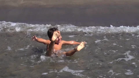 Waves turn over a happy child Stock Footage 68186774