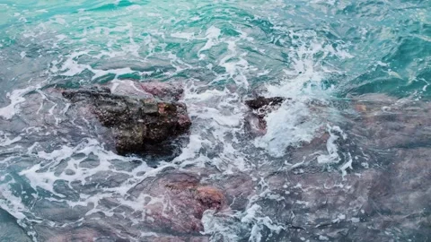 Waves of turquoise sea crash forcefully against rocks creating magnificent sight Stock Footage 244743766
