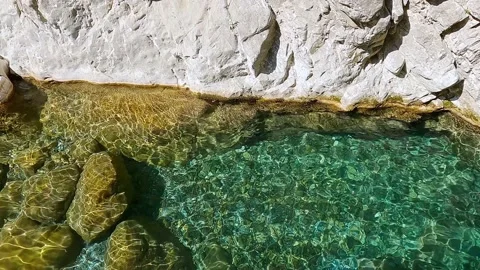 Waves on the turquoise water surface in a mountain gorge Video stock 163890917