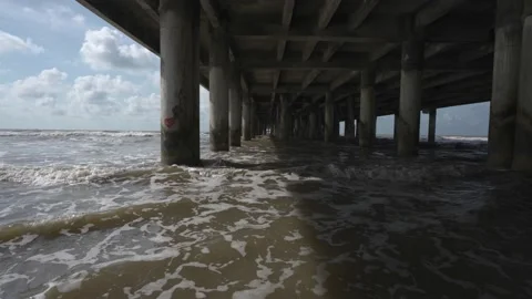 Waves Under Beach Pier On Sunny Day Stock Footage 201448144