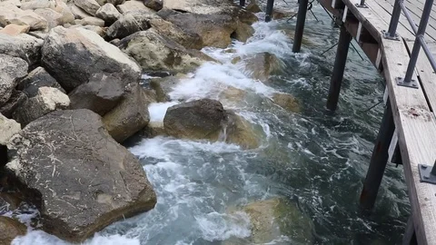 Waves under boardwalk Stock Footage 76179953