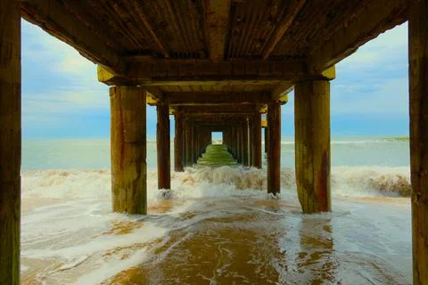 Waves under pier on Atlantic coast beach, slow motion, Villa Gesell, Argentina Stock Photos