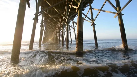 Waves under the pier in the Atlantic Ocean, at Folly Beach, near Charleston, Sou Stock Footage 71631317