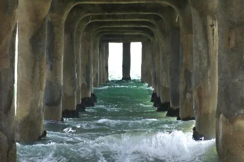 Waves under the pier landscape Stock Photos
