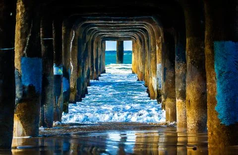 Waves under pier vivid dynamic colors Stock Photos