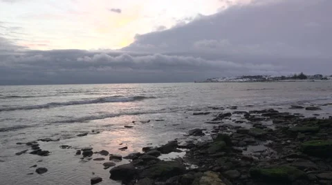 Waves under thunderclouds washed stones. Video stock 53109311