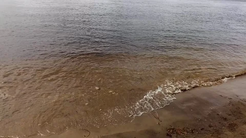 Waves of the Volga river, evenly hitting the sandy shore Stock Footage 129897951
