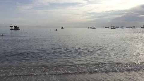 Waves of the warm sea run on the sandy beach early in the morning, Pemuteran Stock Footage