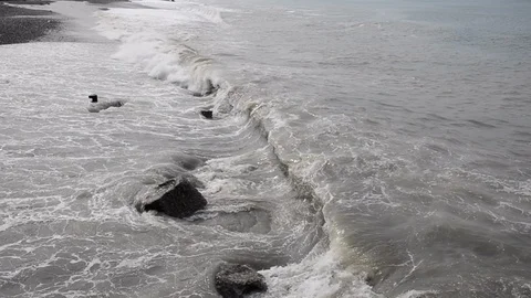 Waves wash the coast on a cloudy day. Video stock 113543187