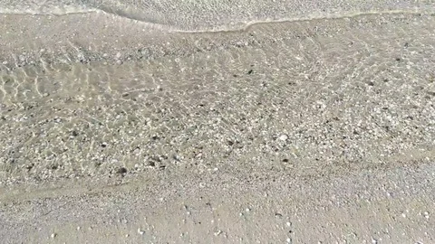 Waves wash the little shells on the sand Stock Footage 112753630
