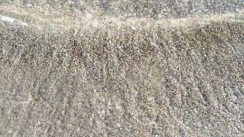 Waves wash the little shells on the sand Video stock 112753674