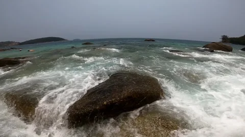 Waves wash over large rocks near the shore. Stock Footage 242167374