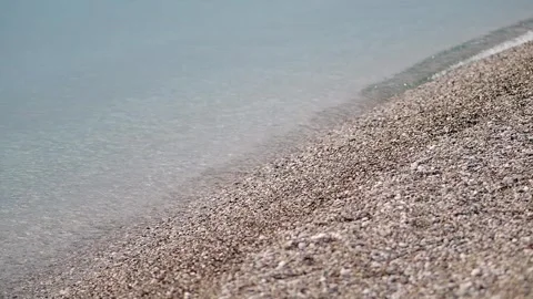 Waves wash over the sandy shore at a beach Stock Footage 333441693