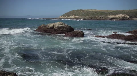 Waves wash over shallow rocks near Spooner’s Cov Stock Footage 62444891