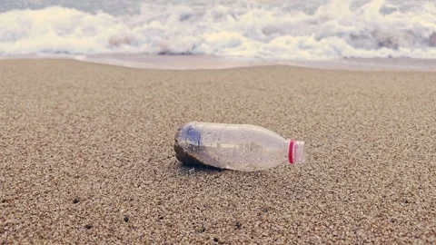The waves washed away the plastic bottles Stock Footage 265571142