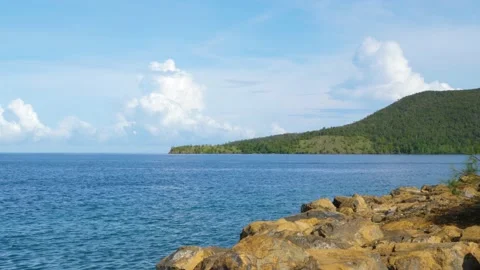 The waves washed over the rocks on the shore. Blue clear water surface 스톡 동영상 153741543