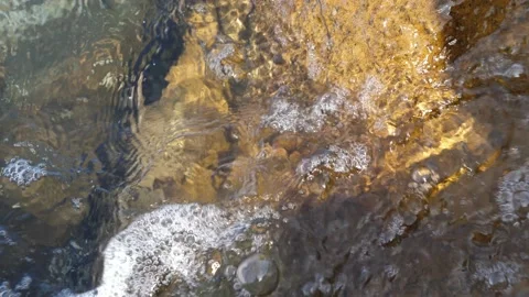 The waves washed over the rocks on the shore. Blue clear water surface 動画素材 153742317