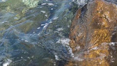 The waves washed over the rocks on the shore. Blue clear water surface 動画素材 153742725