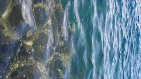 The waves washed over the rocks on the shore. Blue clear water surface 動画素材 153744430