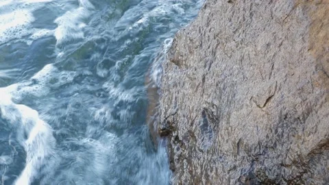 The waves washed over the rocks on the shore. Blue clear water surface 動画素材 153744591