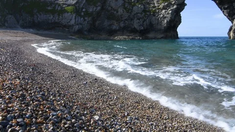 Waves washing against pebbles Stock Footage 91429308