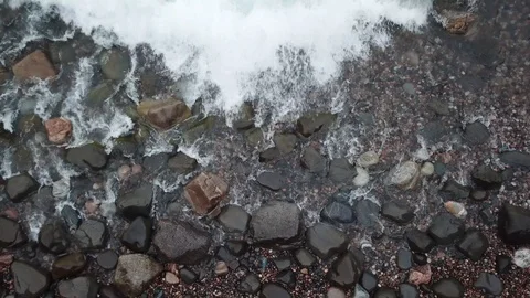 Waves washing ashore from above Stock Footage 86545480