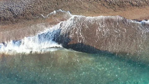 Waves washing ashore. They lap at the shore - break on the sandy beach Stock Footage 135086350