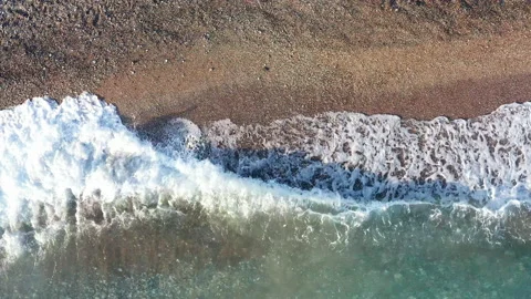 Waves washing ashore. They lap at the shore - break on the sandy beach and ebb Stock Footage 135099574