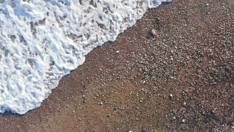 Waves washing ashore. They lap at the shore - break on the sandy beach and ebb Stock Footage 135105294